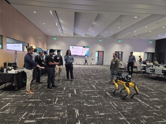 A group of people looking at a robot