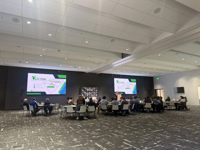 A group of people viewing a presentation